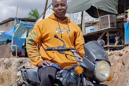 A woman sitting on a motorcycle